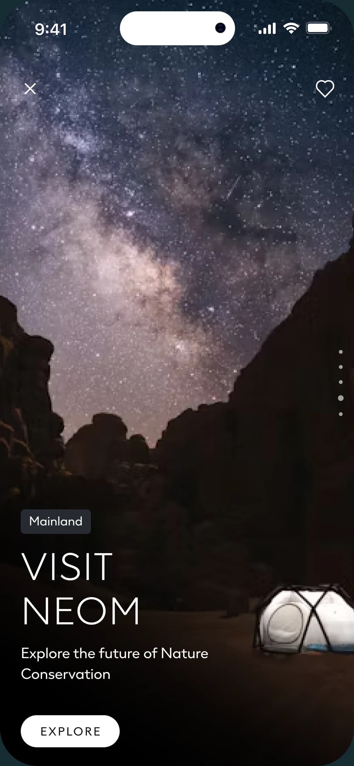 NEOM app screen showing the Milky Way above desert cliffs and a dome tent, tagged Mainland and titled Visit NEOM
